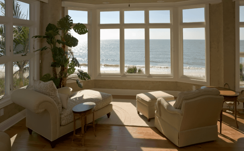 Services | Bright Cleanup Management Airbnb Vacation Rental Cleaning. A pristine living room with a view of the ocean.